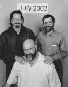 A professional portrait of David (seated) with his boyfriend Keith and husband Peter Tannen, July 2002.