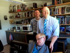 Brett Bigham, his husband Mike Turay, and Dr. Stephen Hawking in Hawking’s office at Cambridge University, England. Photo courtesy of Brett Bigham.