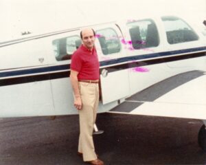 Mel in front of his airplane. He shares, “I owned my own airplane and, for eight years, would commute between Philadelphia and Key West with businesses in both places.”
