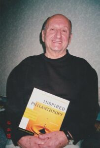 Mel with Kay Lahusen on the book she wrote. He holds a copy of “Inspired Philanthropy, the Second Edition”, December 16, 2009.