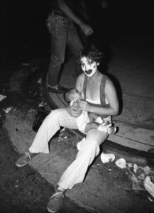 Momma Mime breastfeeding her child at the Sunset Junction Street Fair, Los Angeles, CA, 1981. Photo credit: Louis Jacinto. Photo courtesy of Louis Jacinto.