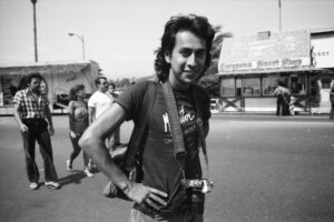 Louis wearing his camera at the Sunset Junction Street Fair, Los Angeles, CA 1982. Photo courtesy of Louis Jacinto.
