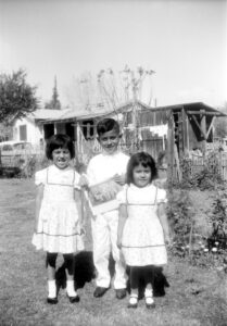 Louis with his two sisters Angela and Susie on his First Holy Communion day, 1963. Photo courtesy of Louis Jacinto.