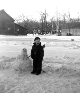 Jay (age 4) with the snowman he built on the farm when he grew up in Southwest Minnesota. Photo courtesy of Jay Kyle Petersen.