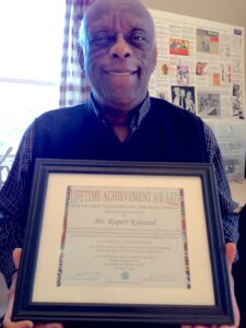 Rupert holding his framed 2013 