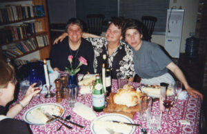 L-R: Judy Abdo, Sheila Kuehl and Linda Garnets smiling at dinner, early 1990s. Judy Abdo and Sheila Kuehl first met in 1978, shortly after Kuehl graduated from Harvard Law School. In 2014, Kuehl was elected to the Los Angeles Board of Supervisors, serving the 3rd District and becoming the first openly lesbian to serve on the Board. Kuehl retired in 2022. Photo courtesy of Santa Monica Public Library Image Archives, Judy Abdo Photo Album Collection.