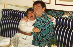 Judy Abdo and Russell Barnard laughing and hugging at a benefit dinner for Santa Monicans for Renters' Rights (SMRR), October 15, 1990. Photo courtesy of Santa Monica Public Library Image Archives, Judy Abdo Photo Album Collection.
