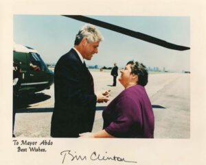 A signed portrait of President Bill Clinton and Santa Monica Mayor Judy Abdo on the jetway and under the helicopter’s blades at Santa Monica Airport, May 20, 1994. It reads, “To Mayor Abdo, Best Wishes, Bill Clinton.” Clinton gave the keynote address at UCLA's 75th anniversary celebration. Air Force One landed at the San Bernardino Airport on the morning of May 20th, where Clinton met with local officials. Marine One then flew the presidential team to Santa Monica Municipal Airport, where Abdo greeted Clinton. Clinton then traveled via motorcade to UCLA. Photo courtesy of Santa Monica Public Library Image Archives, Judy Abdo Photo Album Collection.