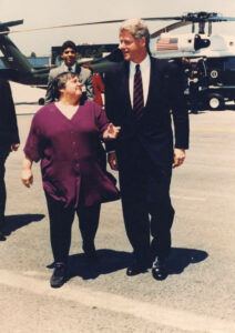 President Bill Clinton and Santa Monica Mayor Judy Abdo chatting while walking down the jetway at the Santa Monica Airport, May 20, 1994. Clinton gave the keynote address at UCLA's 75th anniversary celebration. Air Force One landed at the San Bernardino Airport on the morning of May 20, where Clinton met with local officials. Marine One then flew the presidential team to Santa Monica Municipal Airport, where Abdo greeted Clinton. Clinton then traveled via motorcade to UCLA. Photo courtesy of Santa Monica Public Library Image Archives, Judy Abdo Photo Album Collection.