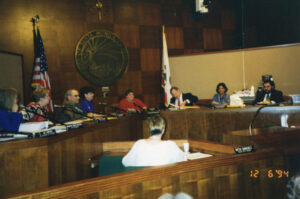Judy Abdo (at center in red) and Councilmembers holding a City Council meeting, December 6, 1994. Photo courtesy of Santa Monica Public Library Image Archives, Judy Abdo Photo Album Collection.