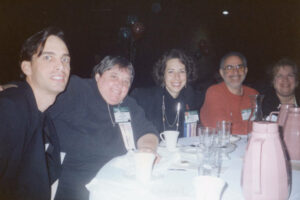 L-R: John Heilman, Judy Abdo, Abbe Land, Paul Rosenstein, and Pam O'Connor at an event, 1990s. John Heilman has served as Councilmember and Mayor in West Hollywood and is one of the longest-serving openly gay elected officials in the U.S. Abbe Land served as Councilmember in West Hollywood from 1986 to 1997 and from 2003 to 2015. Paul Rosenstein served as Santa Monica City Councilmember from 1992 to 2000 and as Mayor from 1994 to 1996. Pam O'Connor is a long time Councilmember in Santa Monica and represents Santa Monica on the Expo Line Board. Photo courtesy of Santa Monica Public Library Image Archives, Judy Abdo Photo Album Collection.