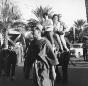 L-R: Judy Ulrich, Mrs. Abdo, and her then-boyfriend Joseph Abdo riding an elephant at a festival. Photo courtesy of Santa Monica Public Library Image Archives, Judy Abdo Photo Album Collection.	