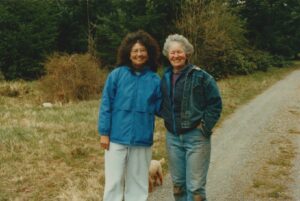 Terri de la Peña and Nancy Nordhoff, the founder of the Hedgebrook writing retreat at Hedgebrook Farm, in front of the Hedgebrook Cottages, Whidbey Island, WA, 1993. Hedgebrook features a Writer-in-Residence Program for “visionary woman-identified writers” at age 18+, and Terri was awarded a writing residency in 1993. Photo courtesy of Terri de la Peña.