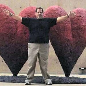 Miguel in front of a double heart sculpture at the Palm Springs Art Museum, Palm Springs, CA, 2014. Photo courtesy of Miguel Criado.