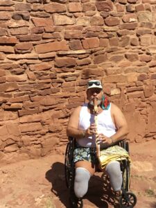 Miguel playing his flute and enjoying the echo at the “awesome ruins”, Pueblo Indian Church, NM, 2021. Photo courtesy of Miguel Criado.