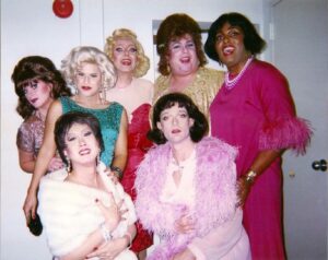 Dale, dressed in dark pink, as FREEda Slave and other cast members on the set of 