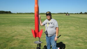 Monica launching an orange and red model rocket. Photo courtesy of Monica Helms.