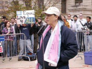 Monica speaking at the Proposition 8 protest and wearing the Transgender Pride Flag that she designed, 2008. Photo courtesy of Monica Helms.