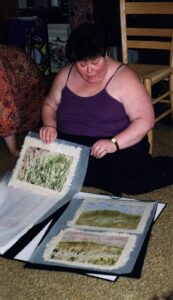 Judith showing various watercolor paintings, 1995. Photo courtesy of Judith Masur.