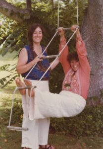 Judith on the wood swing posing next to Sara, 1978. Photo courtesy of Judith Masur.