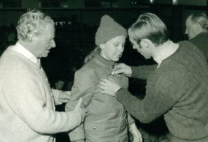 Austrian ski sensation Karl Schranz (right) pinning a medal on Esther after her ski race, 1967-1968. Photo courtesy of Esther Rothblum.
