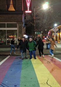 Shelley (at right) and her wife Barbara Belmont (at left) visiting Capitol Hill (Seattle’s LGBTQ+ neighborhood) and crossing the Rainbow Crosswalk, Seattle, WA, February 15, 2020. Photo courtesy of Shelley Diamond.