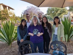 Shelley (at center, holding the award) and her Rothenberg Lab colleagues at the reception for the IDEA Outreach & Education Award, which was sponsored by the Caltech Center for Inclusion & Diversity at California Institute’s Athenaeum Garden, Pasadena, CA, May 18, 2022. L-to-R, top row: Boyoung Shin, Tom Sidwell. L-to-R, bottom row: Boyoung Shin, Shelley Diamond, Tyson Lager, Jamie Tijerina, Sami Chang. Photo courtesy of Shelley Diamond.