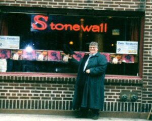 Shelley tipping her tophat while visiting the Stonewall Inn for the first time, Greenwich Village, New York, NY, April 1998. Photo Credit: Barbara Belmont. Photo courtesy of Shelley Diamond.
