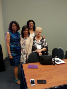 Oliva (at right in black-and-white top) posing with the presenters of “the Legacies of Professor Oliva Espin” symposium, American Psychological Association conference, 2014. Photo courtesy of Oliva Espín.
