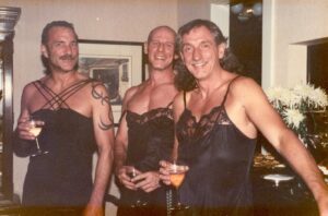 Chuck’s partner Michael Schoch, Rob Welbor, and Chuck Forester wearing in black lingerie and drinking wine, Halloween, 1982. Photo courtesy of Chuck Forester.