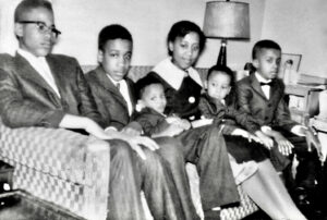 Paul (fifth from left in a patterned suit) and his siblings posing for a family portrait at their home in Lower East Side, New York, NY in the early 1960s. Photo Credit: Paul’s father. Photo courtesy of Paul Outlaw.