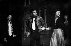 L-R: Paul Outlaw as “Chino”, Keith Love as “Bernardo”, and Laurie Diehl as “Anita” performing in West Side Story at Fisher Theater, Phillips Exeter Academy, Exeter, NH, 1970s. Photo Credit: Bradford Herzog. Photo courtesy of Paul Outlaw.
