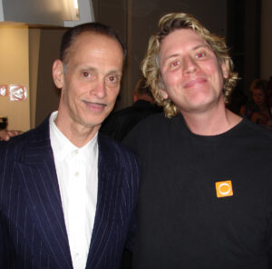 Mike posing with John Waters, April 2002. Mike shares, “Director John Waters was one of the celebrity judges for Mickey Skee's porn awards.” Photo courtesy of Mike Szymanski.