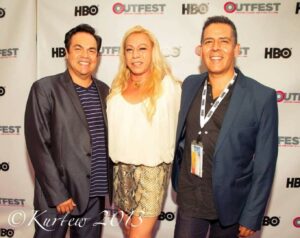 Dante Alencastre (right) smiles with his producer Roland Palencia (left) and activist star-collaborator Bamby Salcedo (center) at the world premiere of “Transvisible: Bamby Salcedo’s Story” during OUTFEST, Los Angeles, CA 2013. Photo credit/copyright Kurfew, 2013. Photo courtesy of Dante Alencastre. 