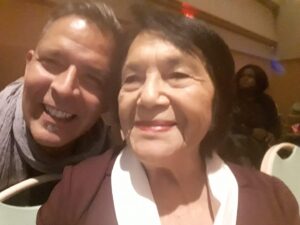 Dante (Left) smiles with Ms. Dolores Huerta in a conference setting in Bakersfield, CA, 
2016. Dante shares he was honored to meet one of his activist idols. Photo courtesy of Dante Alencastre. 