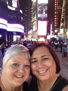 Stephanie Byers smiles with wife Lori Haas in Times Square in New York City, New York, 2018. Photo courtesy of Stephanie Byers.