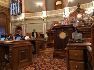 Stephanie speaks at the well of the Kansas House Chamber in an attempt to defeat a bill that would ban trans girls from sports at the Kansas State Capitol, in Topeka, Kansas, 2022. Photo courtesy of Stephanie Byers.