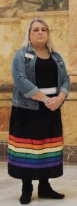 Stephanie in a rainbow ribbon skirt and jean jacket, from Southern Poverty Law Center’s 2022 Report photo shoot. Topeka, Kansas, 2022. Photo courtesy of Stephanie Byers.	