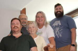 Family photo of a smiling Stephanie Byers (second from right), her parents (left), and sons (far left, and right) in Wichita, Kansas, 2022. Photo courtesy of Stephanie Byers.