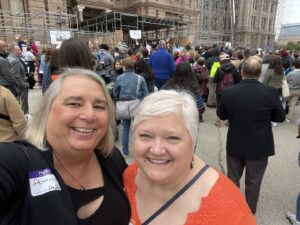 Stephanie Byers (left) smiles with her wife Lori Haas at the “All In For Equality” Rally at the Texas State Capitol, in Austin, Texas, 2023. Photo courtesy of Stephanie Byers.	