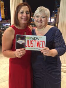 Stephanie Byers and Lori Haas proudly smile and hold up a Las Vegas, Nevada “JUSTWED” license plate on their wedding day in Las Vegas, Nevada, 2015. Photo courtesy of Stephanie Byers.