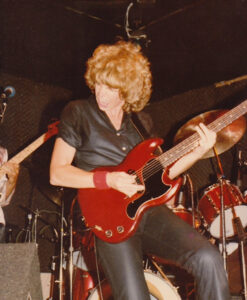 Cidny performing at a live show in California, dressed in black leather, 1979. Photo Credit: Donna Santisi. Photo courtesy of Cidny Bullens.