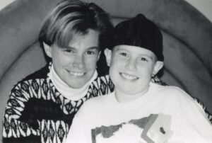 Grayscale photo of Cidny Bullens (L) and his daughter Jessie Bullens (R) during Jessie’s cancer treatment, location, 1995. Photo courtesy of Cidny Bullens.