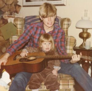 Cidny and his daughter Reid holding a guitar, location, 1984. Photo courtesy of Cidny Bullens.