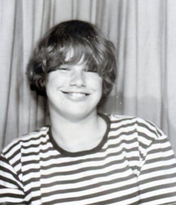 A grayscale photo booth portrait of Cidny, age 15, 1970. Photo courtesy of Cidny Bullens.
