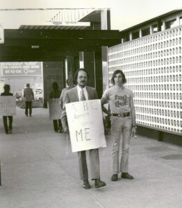 Gerald Gerash holds a sign that reads, 