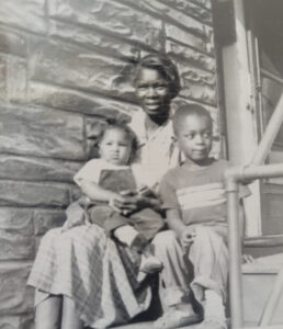 Betty’s grandmother holding Guy (Betty’s brother) and sitting with Betty at right (age 3-4) on the porch stairs in Seattle, WA. Photo courtesy of Betty Berrysmith.