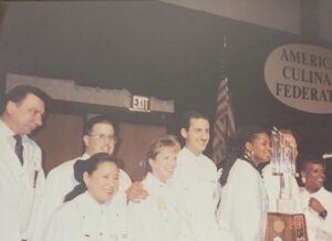 Betty posing in chef’s whites (at left of the trophy) at the awarding ceremony for the Junior Culinary Team competition at the American Culinary Federation’s National Culinary Convention, Washington, D.C., 1992. Photos courtesy of Betty Berrysmith.