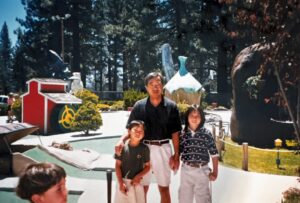 Mini golf photo of brother Stefen (L), father Tad, and Aiden Aizumi. South Lake Tahoe, CA, 1997. Photo courtesy of Marsha Aizumi.