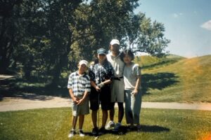 Family golf photo of (L-R) brother Stefen, Aiden, father Tad, and Marsha Aizumi under a tree. City location unknown, CA, circa 1997. Photo courtesy of Marsha Aizumi. 